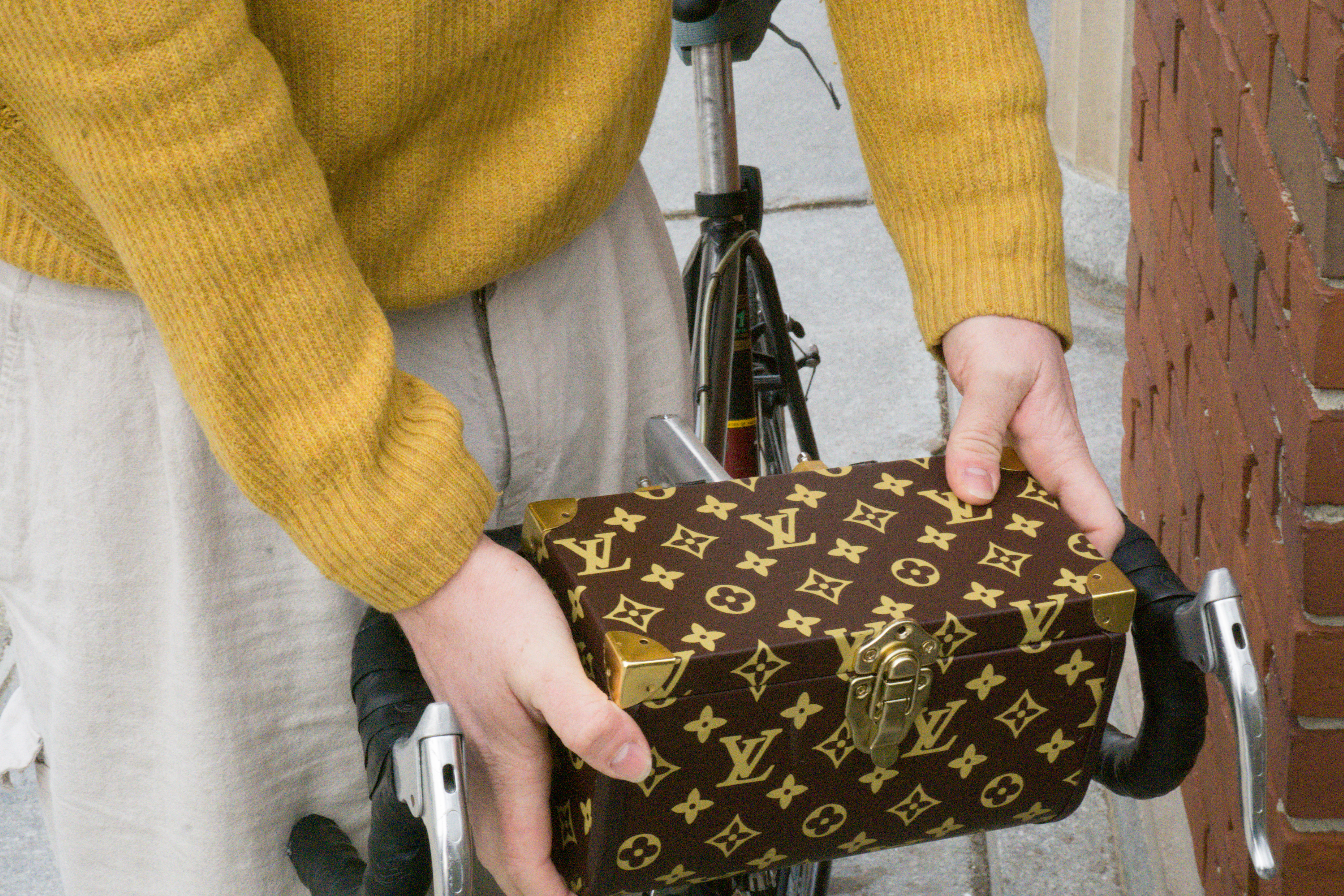 Chris wearing his bike trunk as a carry-on as he departs for work.